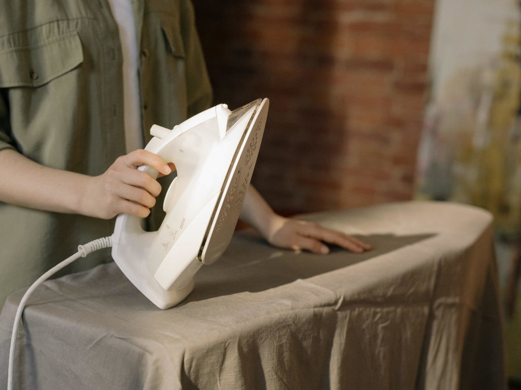 Close Woman's Hand Ironing Cloth Ironing Board Stock Photo by